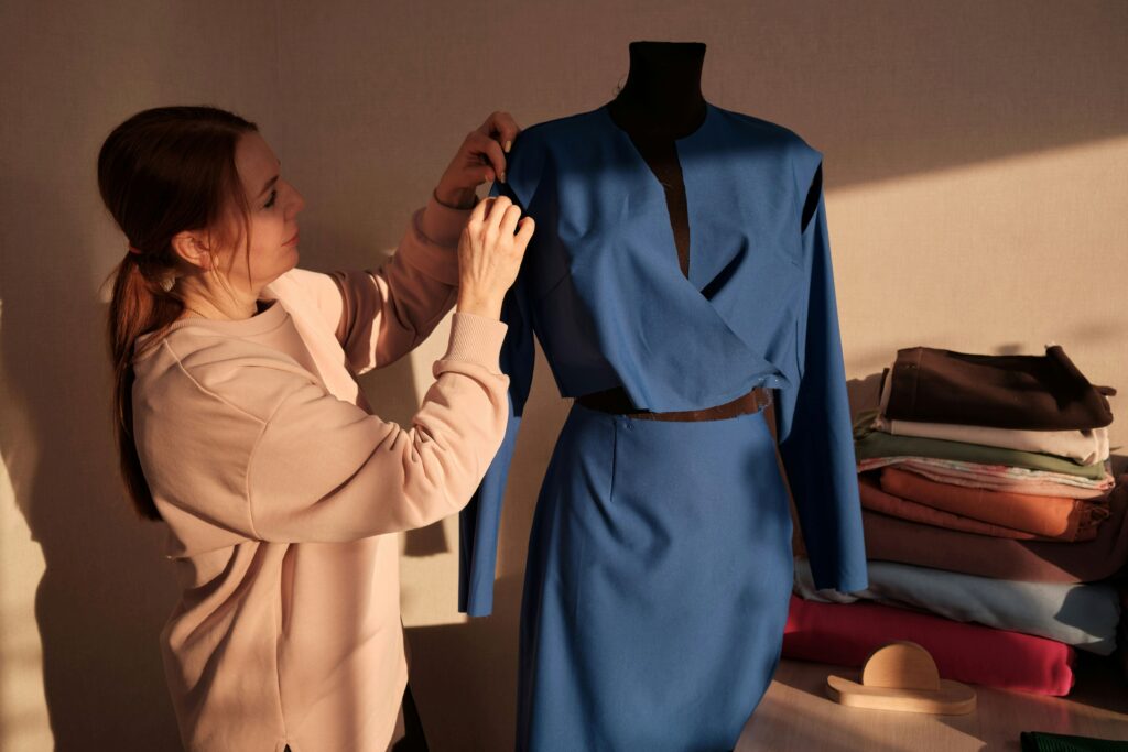 a woman tailoring her clothes